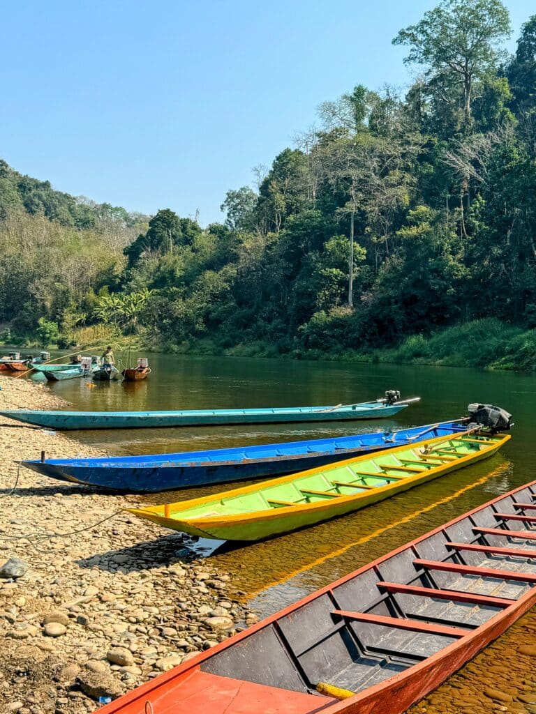boats on river shore in lang prabang