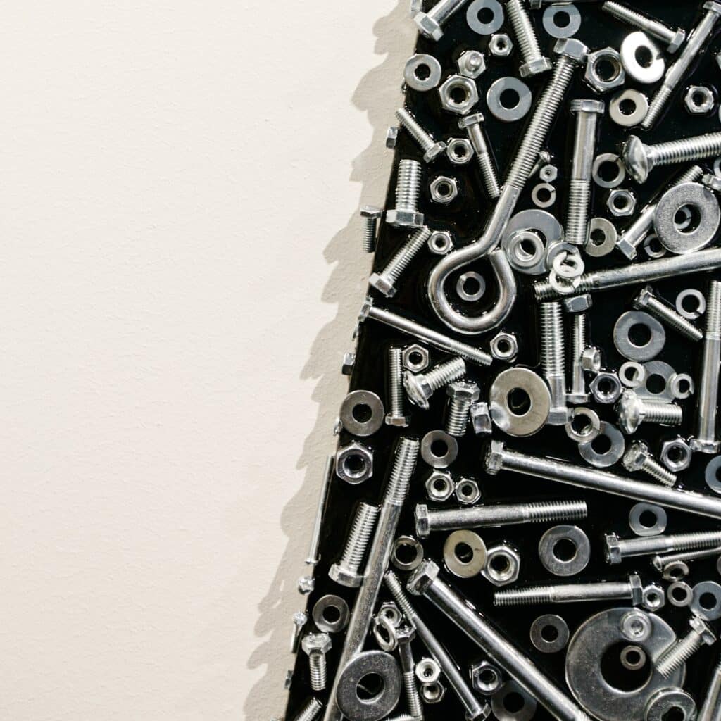 close up of nuts and bolts wall feature at 10 Missions Media