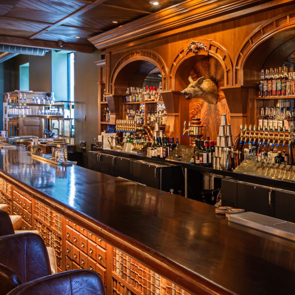 view of bar top and wall-mounted boar head at Butcher and the Boar