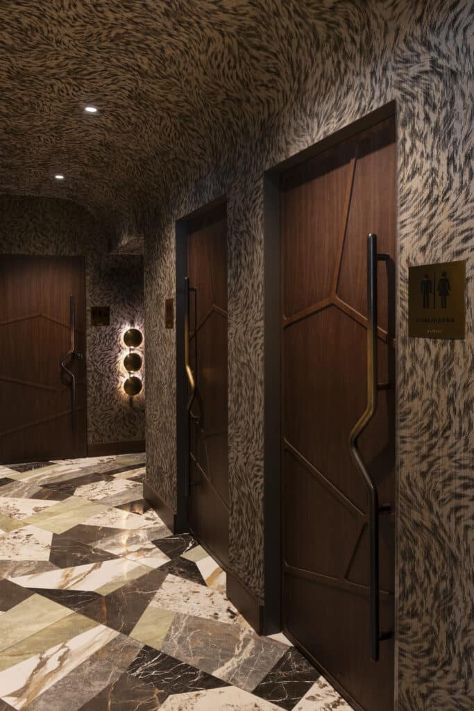 Chayote Barrio Kitchen bathroom doors with patterned wallpaper and textured doors.