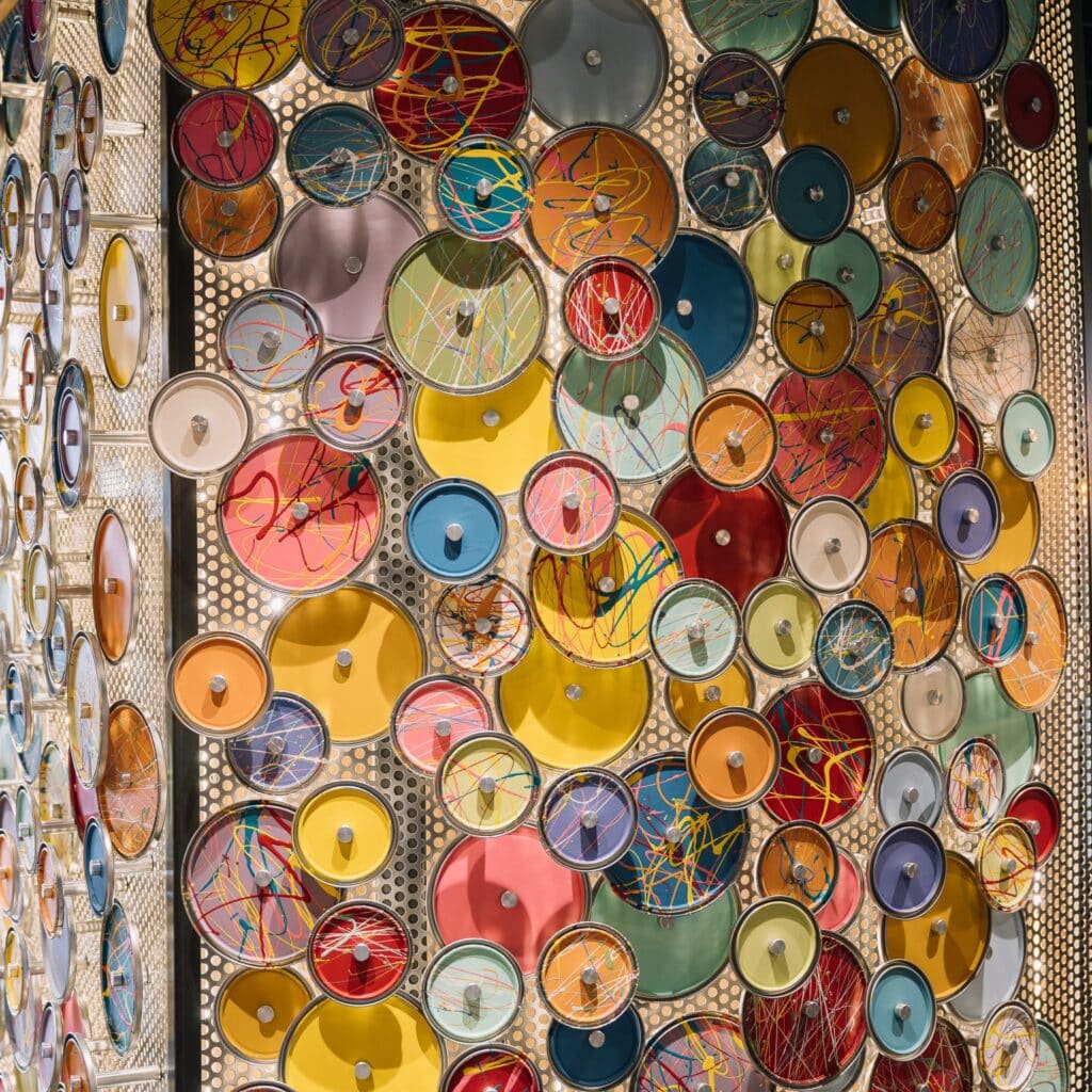 colorful paint can lid wall art