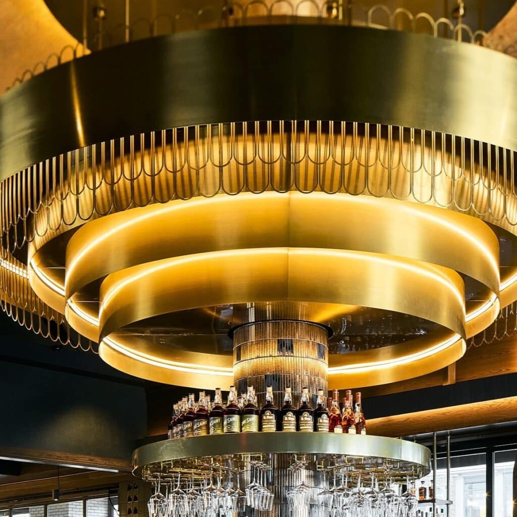 Metal frame circling custom light fixture at 1933 Lounge